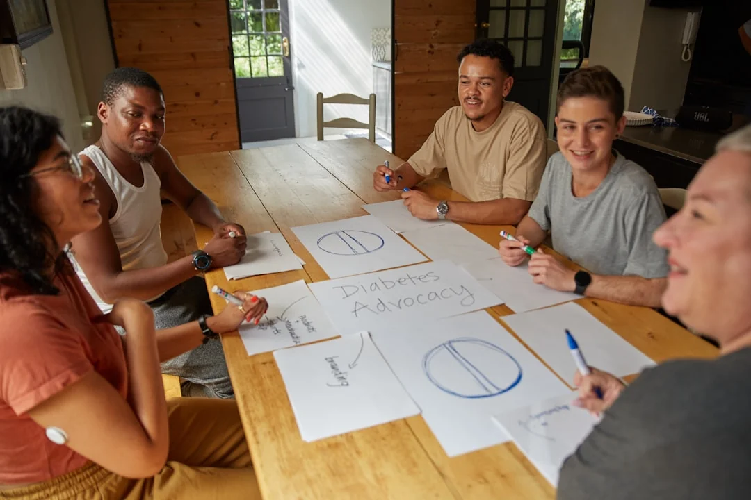 Un espace de travail moderne où des mains analysent des données marketing sur un ordinateur portable et des documents papier.